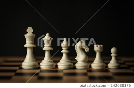 line-up of various white chess pieces on a wooden board, black background line-up of various white chess pieces on a wooden board, black background 142088376
