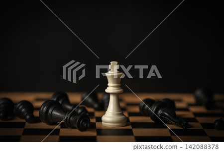 white chess king surrounded by fallen black pieces on wooden board white chess king surrounded by fallen black pieces on wooden board 142088378