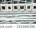 Steel frame loaded with building materials 142088386
