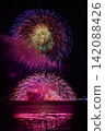 Large fireworks blooming in the summer night sky 142088426