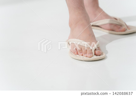 A man's feet wearing sandals A man's feet wearing sandals 142088637