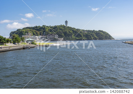 Summer in Shonan: The scenery of Enoshima surrounded by blue skies and the sea. Summer in Shonan: The scenery of Enoshima surrounded by blue skies and the sea. 142088742