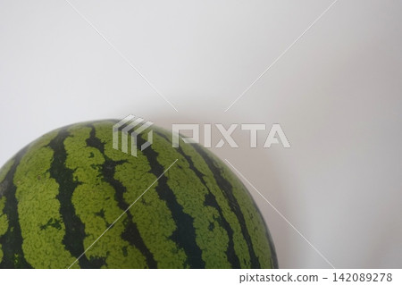 Photo: Watermelon on the edge of the screen, white background Photo: Watermelon on the edge of the screen, white background 142089278