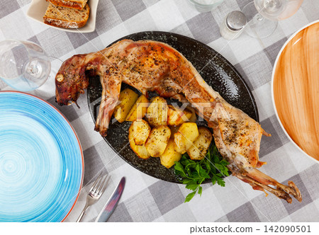 Dish of stewed rabbit with spices and boiled potatoes 142090501