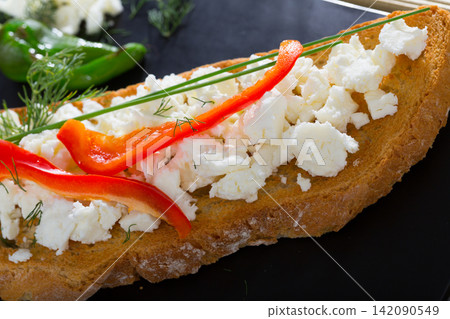 Bulgarian toasted bread with brynza, sweet pepper, greens Bulgarian toasted bread with brynza, sweet pepper, greens 142090549