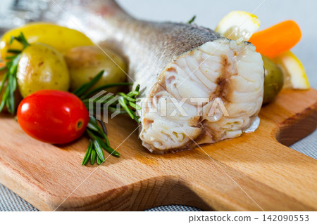Tail of hake by rustically frying and served with boiled potatoes and tomatoes Tail of hake by rustically frying and served with boiled potatoes and tomatoes 142090553