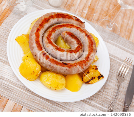 Spanish pork sausages butifarras with potatoes 142090586