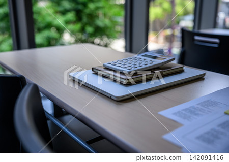 A work scene at an office desk with a calculator and notebook. A work scene at an office desk with a calculator and notebook. 142091416