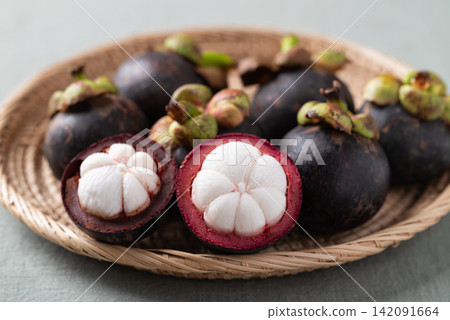 Fresh mangosteen in wicker plate, Tropical fruit in Thailand Fresh mangosteen in wicker plate, Tropical fruit in Thailand 142091664