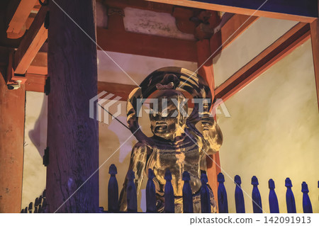 Golden guardian statue illuminated within wooden temple structure Nov 26 2025 Golden guardian statue illuminated within wooden temple structure Nov 26 2025 142091913