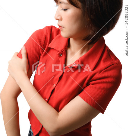 Asian woman feeling painful muscle ache holding injured arm with distressed expression wearing red shirt studio portrait cutout 142092325