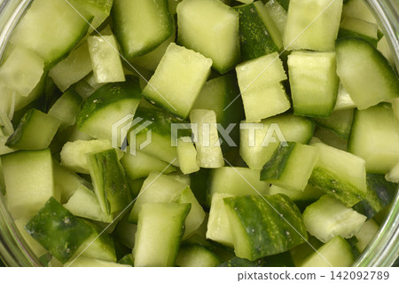 Chopped fresh green cucumber cubes in a jar close up Chopped fresh green cucumber cubes in a jar close up 142092789