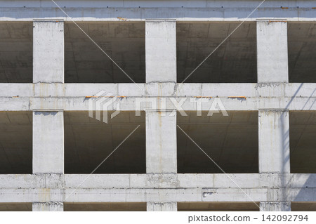 Concrete building construction site with open window frames Concrete building construction site with open window frames 142092794