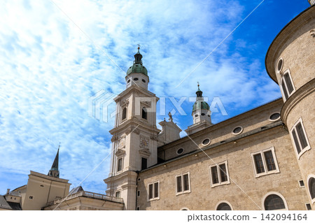 Salzburg Cathedral Towers with Beautiful Blue Sky and Clouds View from Kapitelplatz Austria Europe Salzburg Cathedral Towers with Beautiful Blue Sky and Clouds View from Kapitelplatz Austria Europe 142094164