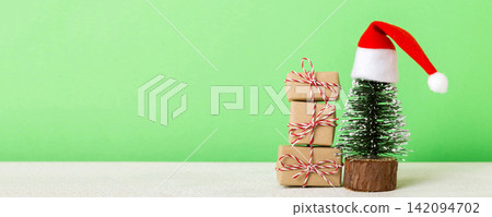 Christmas composition. Gifts, small tree, branches and craft DIY decorations on white background. New year concept. Christmas home decoration Flat lay, top view, copy space Christmas composition. Gifts, small tree, branches and craft DIY decorations on white background. New year concept. Christmas home decoration Flat lay, top view, copy space 142094702