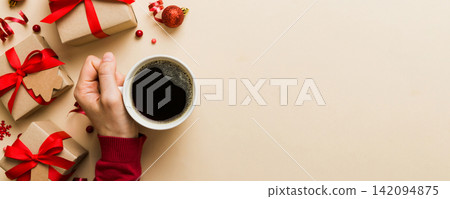 Woman holding cup of coffee. Woman hands holding a mug with hot coffee. Winter and Christmas time concept Woman holding cup of coffee. Woman hands holding a mug with hot coffee. Winter and Christmas time concept 142094875