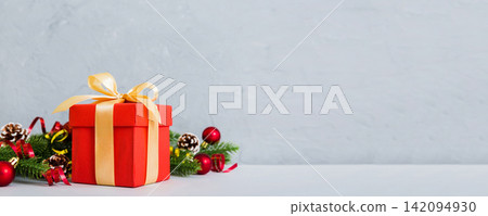 New Year Christmas mood, gift box, branches of a christmas tree, New Year decorations on a colored background 142094930