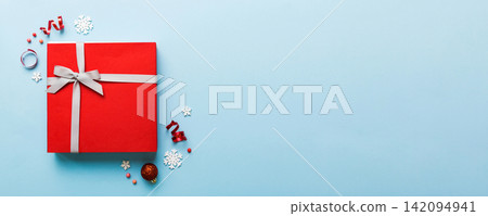 Top view Flat lay Christmas decorations and gift box on colored background with copy space. Christmas or Happy New Year composition 142094941