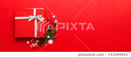 Top view Flat lay Christmas decorations and gift box on colored background with copy space. Christmas or Happy New Year composition Top view Flat lay Christmas decorations and gift box on colored background with copy space. Christmas or Happy New Year composition 142094942