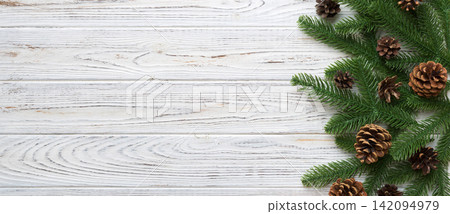 Christmas holiday background with copy space for advertising text. Fir branches and pine cone on color background . Flat lay, top view Christmas holiday background with copy space for advertising text. Fir branches and pine cone on color background . Flat lay, top view 142094979