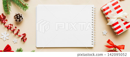 Christmas blank greeting card mock-up scene. Creative layout made of Christmas tree branches and paper card note. Flat lay. Nature New Year concept Christmas blank greeting card mock-up scene. Creative layout made of Christmas tree branches and paper card note. Flat lay. Nature New Year concept 142095052