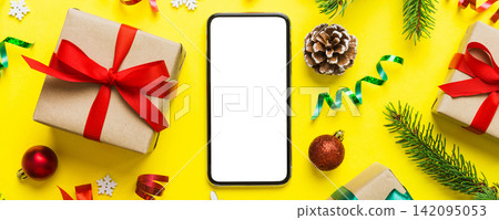 Digital phone mock up with rustic Christmas decorations for app presentation top view with empty space for you design. Christmas online shopping concept. Tablet with copy space on colored background Digital phone mock up with rustic Christmas decorations for app presentation top view with empty space for you design. Christmas online shopping concept. Tablet with copy space on colored background 142095053