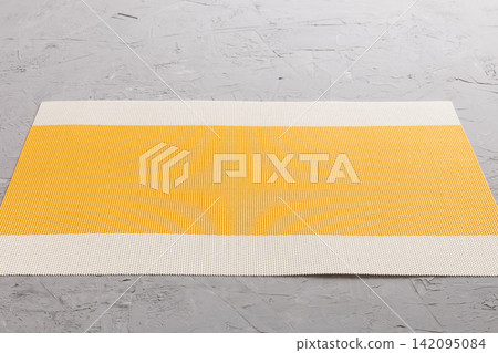 Perspective view of yellow tablecloth for food on cement background. Empty space for your design Perspective view of yellow tablecloth for food on cement background. Empty space for your design 142095084