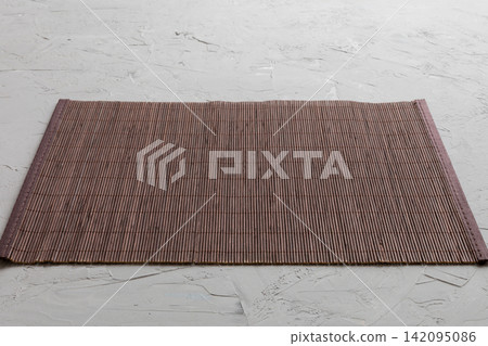 Perspective view of brown tablecloth for food on cement background. Empty space for your design Perspective view of brown tablecloth for food on cement background. Empty space for your design 142095086