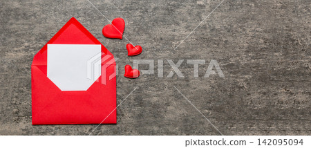 Red paper envelope with empty white card and heart on colored background. top view valentines day concept Red paper envelope with empty white card and heart on colored background. top view valentines day concept 142095094