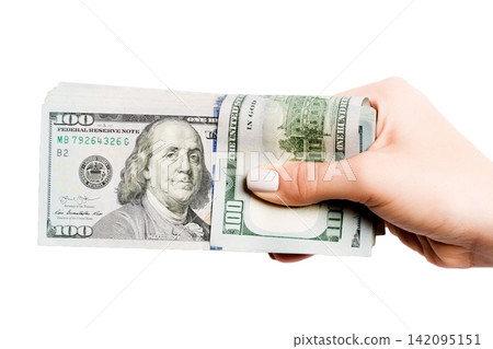 Dollar banknotes in female hand on white isolated background. Business concept Dollar banknotes in female hand on white isolated background. Business concept 142095151
