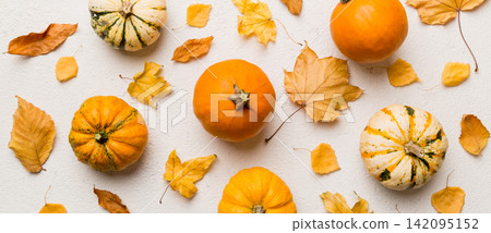 Autumn composition. Pattern made of dried leaves and other design accessories on table. Flat lay, top view Autumn composition. Pattern made of dried leaves and other design accessories on table. Flat lay, top view 142095152