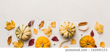 Autumn composition. Pattern made of dried leaves and other design accessories on table. Flat lay, top view Autumn composition. Pattern made of dried leaves and other design accessories on table. Flat lay, top view 142095153