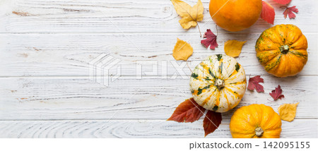 Autumn composition. Pattern made of dried leaves and other design accessories on table. Flat lay, top view 142095155