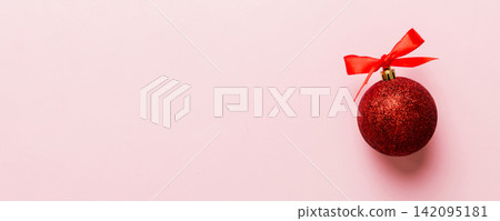 Christmas ball on colored background. decoration bauble with ribbon bow with copy space Christmas ball on colored background. decoration bauble with ribbon bow with copy space 142095181
