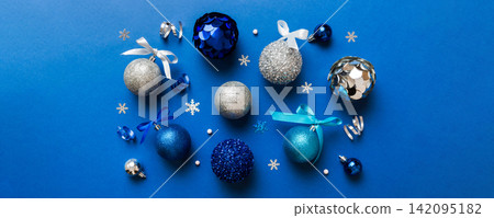 Christmas ball on colored background. decoration bauble with ribbon bow with copy space 142095182