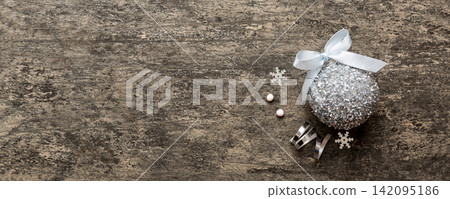 Christmas ball on colored background. decoration bauble with ribbon bow with copy space Christmas ball on colored background. decoration bauble with ribbon bow with copy space 142095186