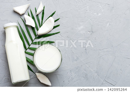 coconut products on white wooden table background. Dairy free milk substitute drink, Flat lay healthy eating coconut products on white wooden table background. Dairy free milk substitute drink, Flat lay healthy eating 142095264