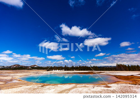 Grand Prismatic Spring at Yellowstone National Park, colorful geothermal hot spring pool under bright blue sky, Wyoming USA Grand Prismatic Spring at Yellowstone National Park, colorful geothermal hot spring pool under bright blue sky, Wyoming USA 142095314