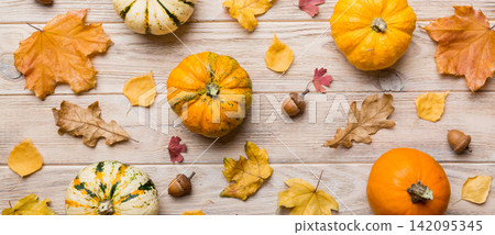 Autumn composition. Pattern made of dried leaves and other design accessories on table. Flat lay, top view Autumn composition. Pattern made of dried leaves and other design accessories on table. Flat lay, top view 142095345