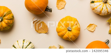Autumn composition. Pattern made of dried leaves and other design accessories on table. Flat lay, top view Autumn composition. Pattern made of dried leaves and other design accessories on table. Flat lay, top view 142095346