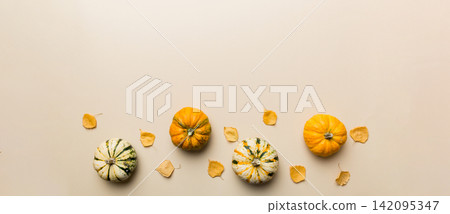 Autumn composition. Pattern made of dried leaves and other design accessories on table. Flat lay, top view Autumn composition. Pattern made of dried leaves and other design accessories on table. Flat lay, top view 142095347