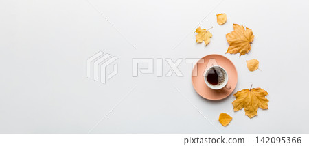 Flat lay composition with colorful Autumn cup of coffee and leaves on a color background. top view Flat lay composition with colorful Autumn cup of coffee and leaves on a color background. top view 142095366