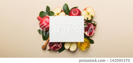 Flat lay composition with Blank flyer poster and symbols jewish Rosh Hashanah holiday attributes on colored background, New Year holiday Traditional. Top view with copy space mock up Flat lay composition with Blank flyer poster and symbols jewish Rosh Hashanah holiday attributes on colored background, New Year holiday Traditional. Top view with copy space mock up 142095370