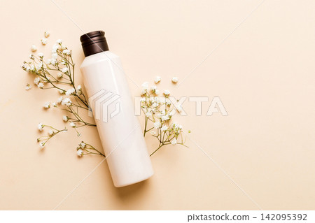 Fancy healthcare bottles for cream with gypsophila branch. Natural oranic spa cosmetics concept. Mockup, template, Top view Fancy healthcare bottles for cream with gypsophila branch. Natural oranic spa cosmetics concept. Mockup, template, Top view 142095392