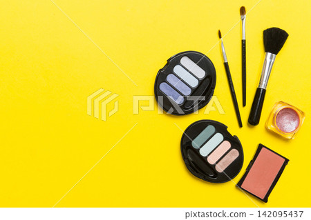 Professional makeup tools. Top view. Flat lay. Beauty, decorative cosmetics. Makeup brushes set and color eyeshadow palette on table background. Minimalistic style Professional makeup tools. Top view. Flat lay. Beauty, decorative cosmetics. Makeup brushes set and color eyeshadow palette on table background. Minimalistic style 142095437