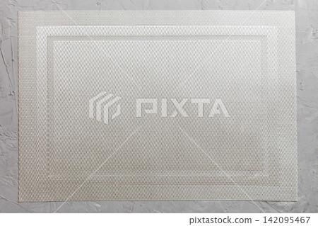 Top view of grey tablecloth for food on cement background. Empty space for your design Top view of grey tablecloth for food on cement background. Empty space for your design 142095467