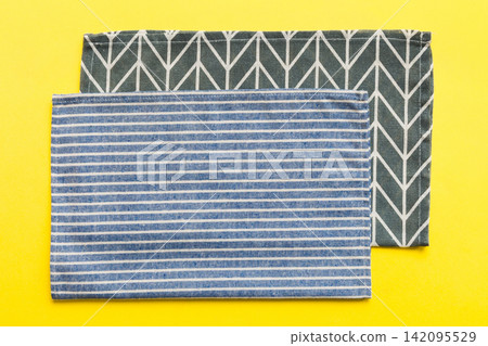 top view with blue kitchen napkin isolated on table background. Folded cloth for mockup with copy space, Flat lay. Minimal style top view with blue kitchen napkin isolated on table background. Folded cloth for mockup with copy space, Flat lay. Minimal style 142095529