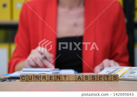 Exploring current assets in a bright office setting with organized paperwork and financial details Exploring current assets in a bright office setting with organized paperwork and financial details 142095643