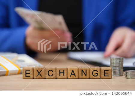 Counting coins and arranging notes during a lively currency exchange at a local market Counting coins and arranging notes during a lively currency exchange at a local market 142095644