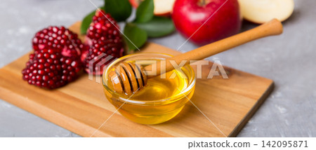 Rosh hashanah, jewish holiday, concept: honey, apple and pomegranate with cutting board, close up Rosh hashanah, jewish holiday, concept: honey, apple and pomegranate with cutting board, close up 142095871